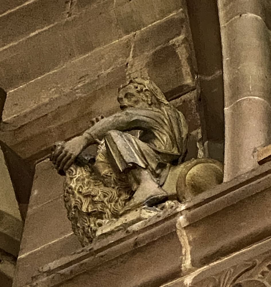 Statue : homme assis sur un pilier de la cathédrale de Strasbourg