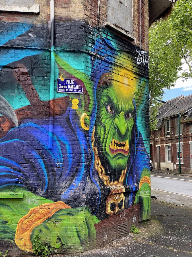 Maison en briques rouges recouverte d'une fresque de street art dans la cité minière de Lens